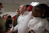 A migrant is detained by federal immigration officers at U.S. immigration court