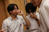 Secondary school students react after receiving their Diploma of Secondary Education (DSE) exam results in Hong Kong