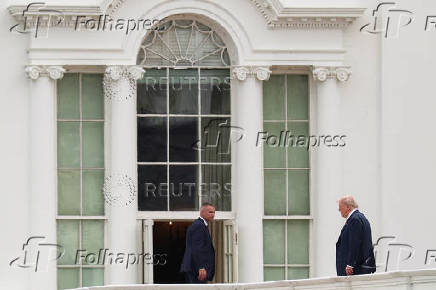 U.S. President Trump walks on the roof of the White House in Washington