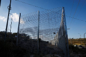 Israeli authorities encircle Palestinian town in West Bank with a fence, restricting free movement of residents
