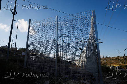 Israeli authorities encircle Palestinian town in West Bank with a fence, restricting free movement of residents
