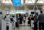 Travellers are seen in the Delta Airlines check-in area at John F. Kennedy International Airport (JFK) in New York City
