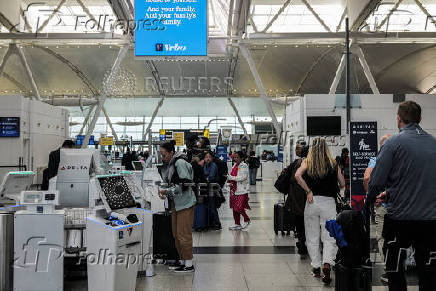Travellers are seen in the Delta Airlines check-in area at John F. Kennedy International Airport (JFK) in New York City