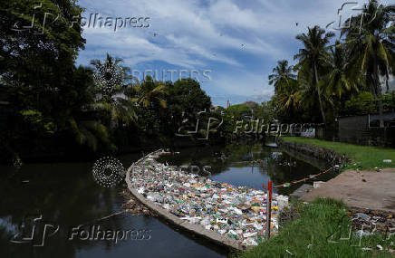 FILE PHOTO: A barrier in the water stops discarded plastics and other materials from flowing into the sea, in Colombo