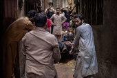 Buffalo is held ahead of sacrificial slaughter during Eid al-Adha in Lahore