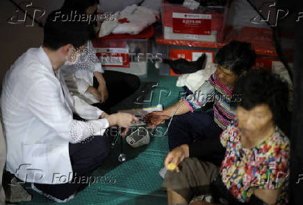 People evacuated from villages, damaged by torrential rain, rest at a temporary shelter, in Yesan,