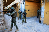 Israeli troops stand guard during a weekly settlers' tour in Hebron