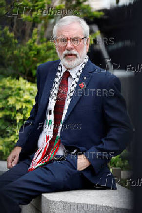 Former Sinn Fein President Gerry Adams sits outside the High Court, in Dublin