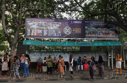 A banner for the upcoming 72nd Miss World pageant is displayed at a bus stop in Hyderabad