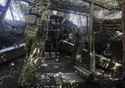 Ukrainian servicemen hold a position in the Kharkiv region