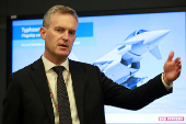 Richard Hamilton, Director for Europe and international in the Air sector of BAE Systems, gives a presentation in front of an image of one of their Typhoon military jets at their Warton factory in Warton
