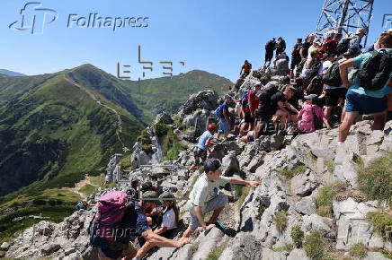 Hikers on the Giewont summit in the Tatra Mountains