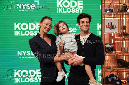 Karlie Kloss, founder of Kode With Klossy, poses for pictures with her family at the New York Stock Exchange (NYSE) in New York City