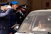 Pope Francis looks on as he leaves Regina Coeli prison after a visit, in Rome