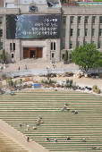 Workers plant lawn in front of Seoul City Hall