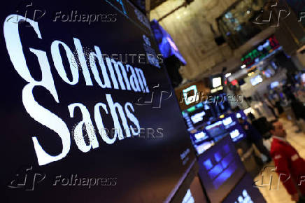 A screen displays the the company logo for Goldman Sachs  on the floor of the NYSE in New York