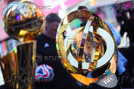 2025 NBA Champion Larry O'Brien Trophy and FIFA Club World Cup 2025 winners trophy are displayed in Times Square in New York City