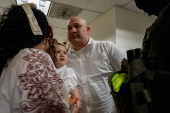 A migrant is detained by federal immigration officers at U.S. immigration court