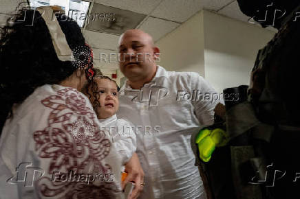 A migrant is detained by federal immigration officers at U.S. immigration court