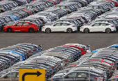 Honda vehicles are lined up at a vehicle storage yard at an industrial port in Yokohama