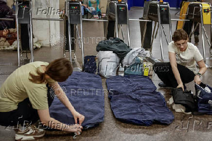 People take shelter inside a metro station during an air raid alert in Kyiv