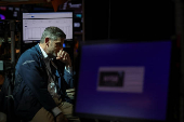 A trader works on the floor at the New York Stock Exchange (NYSE) in New York City