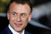 French President Emmanuel Macron looks on, upon his arrival at military airbase Halim Perdanakusuma in Jakarta