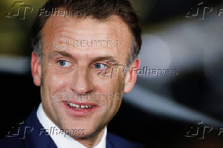 French President Emmanuel Macron looks on, upon his arrival at military airbase Halim Perdanakusuma in Jakarta