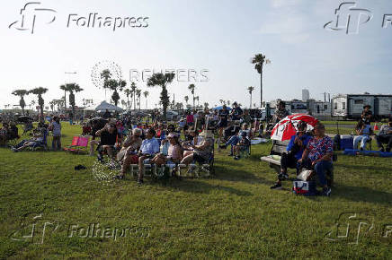 People wait to watch SpaceX's next-generation Starship spacecraft atop its Super Heavy booster launch