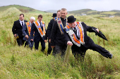 Members of the Orange Order pictured following a march along the beach in Rossnowlagh in County Donegal
