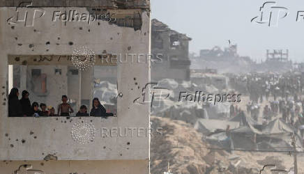 Palestinians carry aid supplies that entered Gaza through Israel, in Beit Lahia