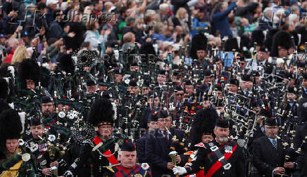 Members of a Pipe band march during the Braemar Royal Highland Gathering at the Princess Royal and Duke of Fife Memorial Park in Braemar
