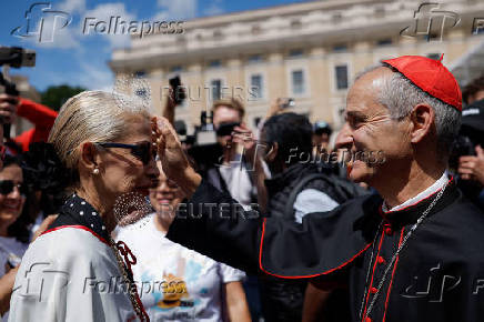 Cardinal Jean-Paul Vesco meets people ahead of the conclave to elect the next pope, as seen from Rome