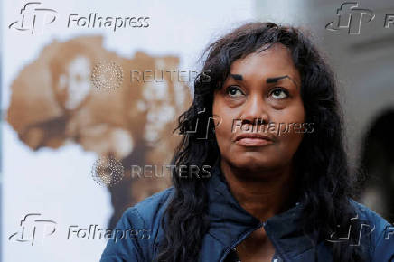 FILE PHOTO: Tamara Lanier listens as her lawyer speaks to the media outside of the Harvard Club in New York