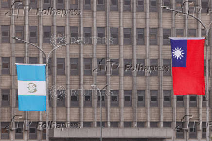 The national flags of Taiwan and Guatemala flutter outside the Presidential Office Building in Taipei