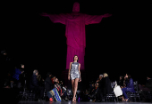 Models present creations by Alessa at the Christ the Redeemer statue to mark the launch of Rio Fashion Show, in Rio de Janeiro