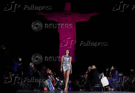 Models present creations by Alessa at the Christ the Redeemer statue to mark the launch of Rio Fashion Show, in Rio de Janeiro