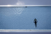 People swim in the Sky Pool during hot weather in London