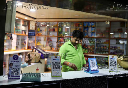 FILE PHOTO: QR codes of digital payment firms PhonePe and Paytm are seen on the counter of a grocery store in Ahmedabad