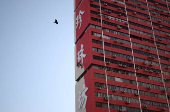 Workers paint the facade of People?s Park Complex, a residential building popular with social media content creators, in Chinatown, Singapore