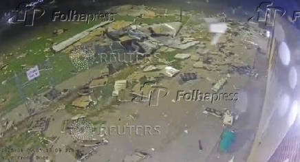Roof debris is scattered across the grounds of the Nebraska State Penitentiary during a storm in Lincoln