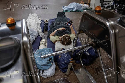 People take shelter inside a metro station during an air raid alert in Kyiv