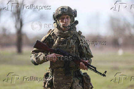Young recruit of the Ukrainian Armed Forces poses for a picture in Kyiv region