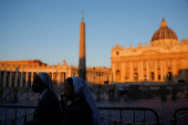 Nuns walk in front of St. Peter's Basilica, ahead of the conclave which will be held on May 7, as seen from Rome