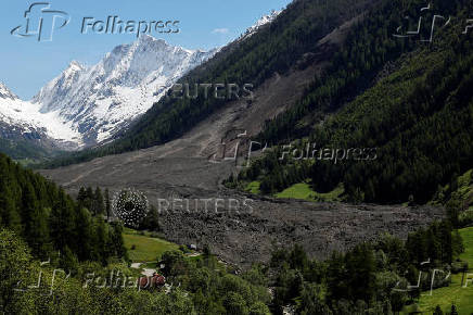 Debris and dust from a crumbling glacier that partially collapsed and tumbled onto the village of Blatten