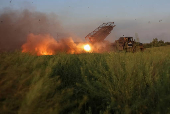 Ukrainian servicemen fire a Grad MLRS towards Russian troops in Donetsk region