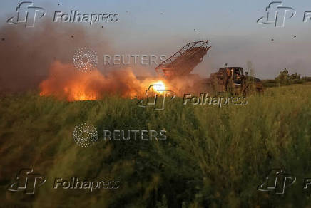 Ukrainian servicemen fire a Grad MLRS towards Russian troops in Donetsk region