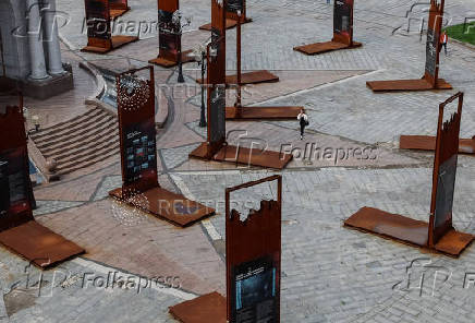 A woman walks past an installation at the Independence Square in central Kyiv
