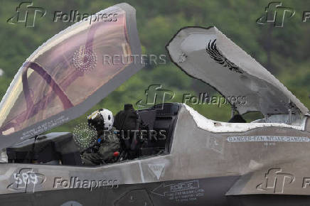 A U.S. Marine Corps pilot sits in the cockpit of an F-35 fighter jet after landing at the former Roosevelt Roads military base in Ceiba