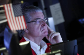 Traders work on the floor at the New York Stock Exchange, in New York City